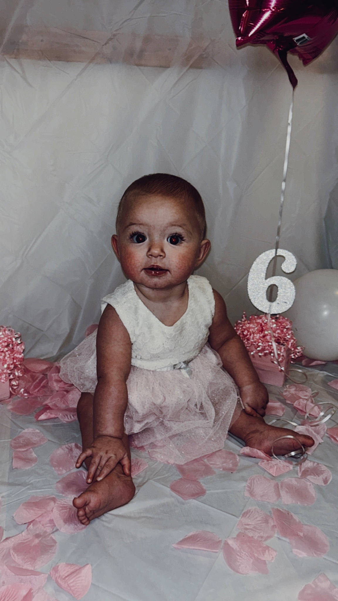 Ember is registered to the contest to win money with this photo: baby, baby_toddler_clothing, balloon, child, dress, event, flash_photography, flooring, fun, happy, head, jewellery, linens, person, pink, room, sitting, skin, textile, toddler