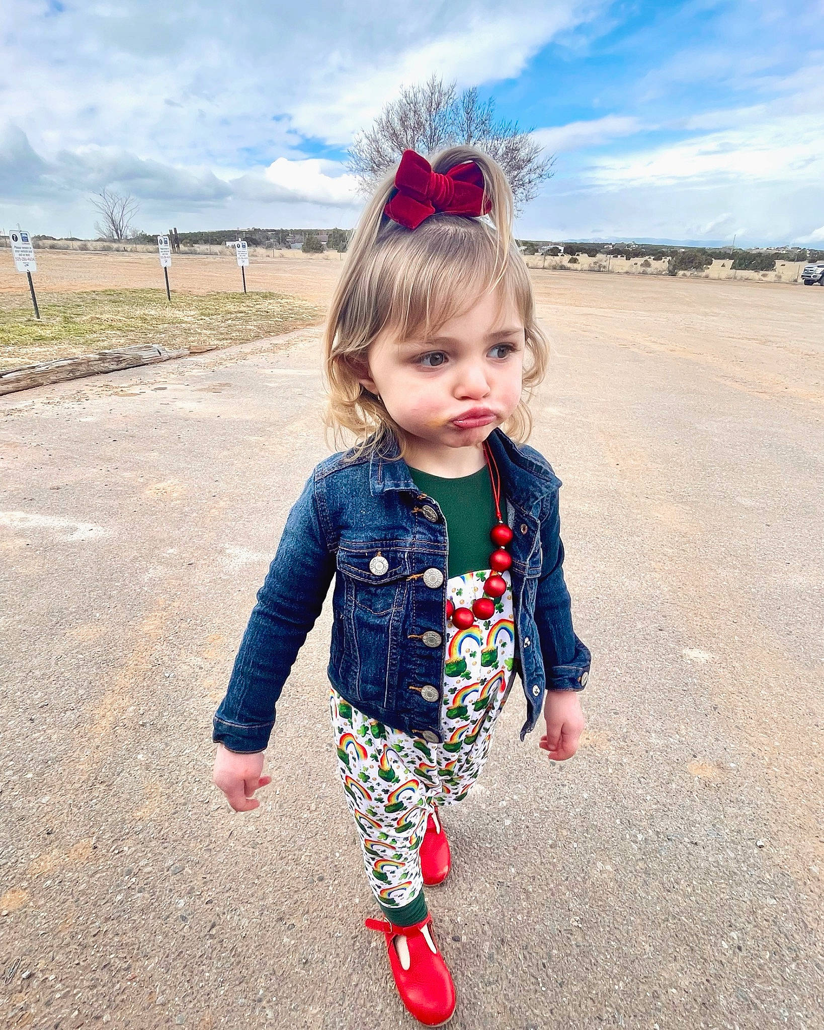 Emma is registered to the contest to win money with this photo: baby_toddler_clothing, brown_hair, child, cloud, electric_blue, fashion_accessory, fun, grass, grassland, happy, landscape, magenta, pattern, people_in_nature, person, plaid, sky, sleeve, summer, toddler
