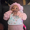 Niriyah Christina is registered to the contest to win money with this photo: baby, infant, child, portrait, pink_clothing, bonnet, pajamas, sitting, lying_down, smiling, face, hands, floral_pattern, couch, lap, indoor, office_chairs, carpet, cables, home_photo