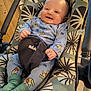 Ethan participe au concours pour gagner de l'argent avec cette photo : baby, smiling, onesie, baby_rocker, blue_clothing, indoor, child, infant, happy, cute, seat, patterned_fabric, toy, person, small_child, comfort, playful, legs, socks, face