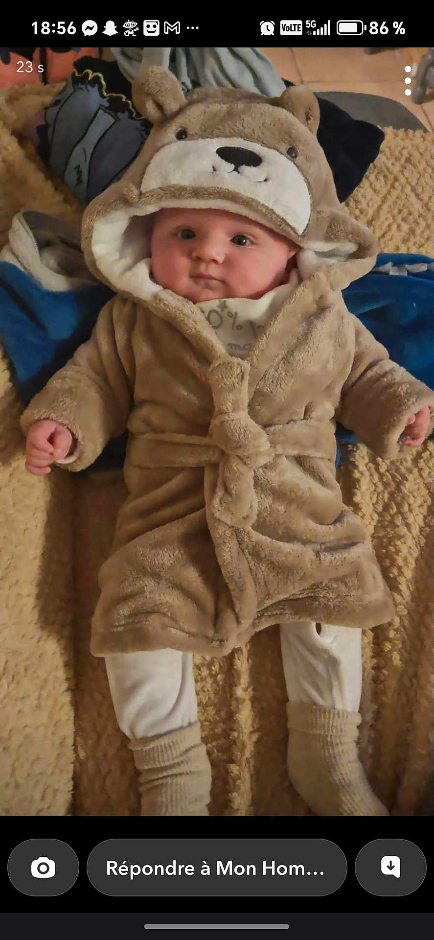 Ethan participe au concours pour gagner de l'argent avec cette photo : baby, child, fuzzy_robe, bear_hood, blanket, pillow, indoor, cute, infant, soft_texture, white_pants, socks, lying_down, portrait, warm_clothing, cozy, face, person, expression, comfortable