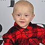toddler, child, baby, plaid_shirt, red_shirt, black_shirt, portrait, smiling, blue_eyes, short_hair, basket, indoor, studio, background_text, fashion, cute, person, young_child, buttoned_shirt, seated