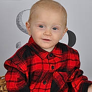 Harley participe au concours pour gagner de l'argent avec cette photo : toddler, child, portrait, red_shirt, plaid, blue_eyes, light_hair, smiling, seated, basket_chair, indoor, studio, casual_clothing, cute, young_child, face, person, buttoned_shirt, background_text, cozy