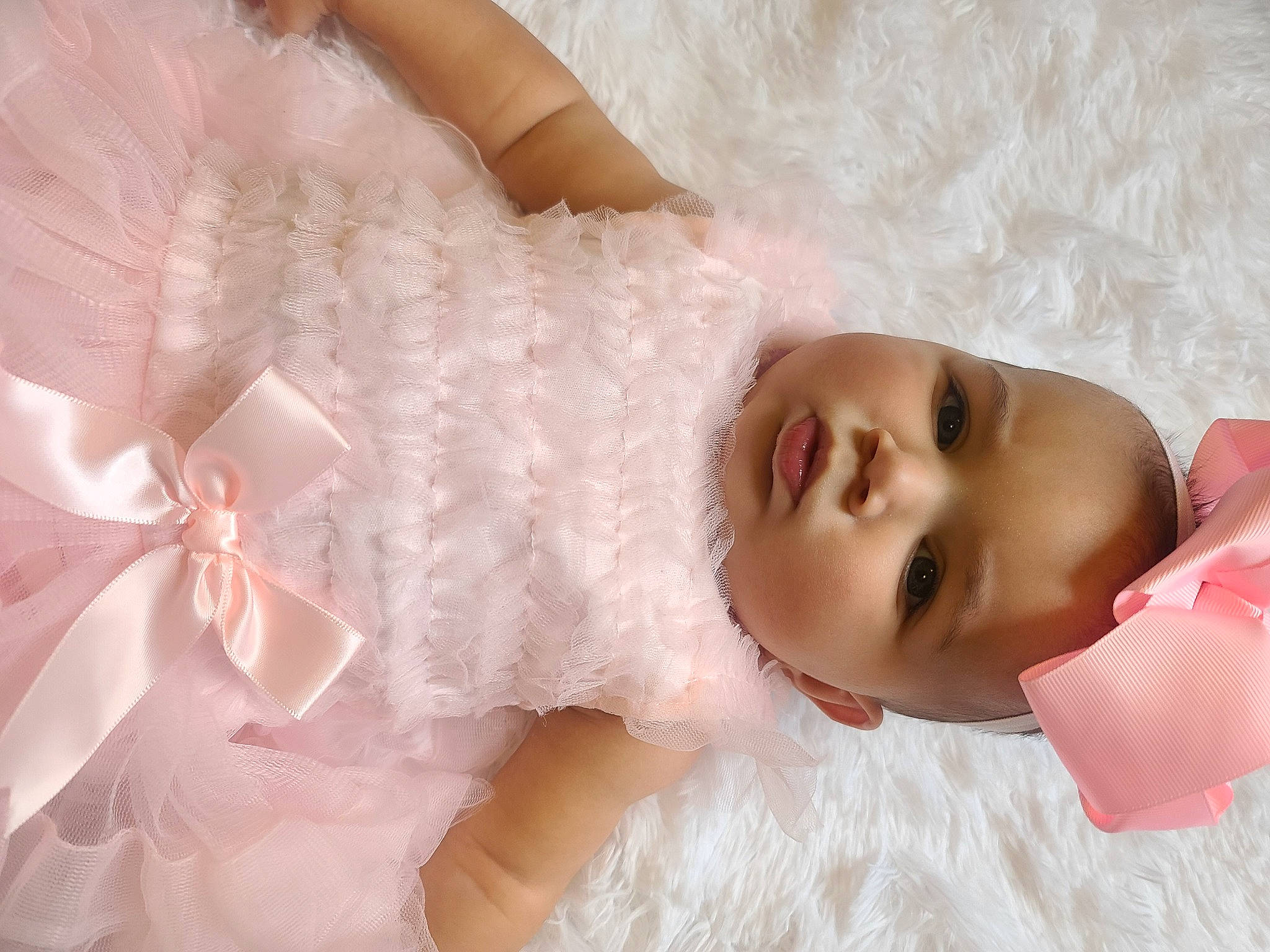 Kinsley is registered to the contest to win money with this photo: baby, baby_products, baby_toddler_clothing, cheek, child, costume_accessory, day_dress, embellishment, hair_accessory, lace, lip, peach, person, pink, satin, skin