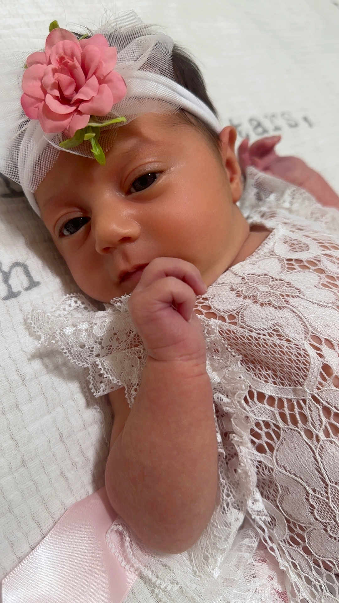 Kiara is registered to the contest to win money with this photo: baby, infant, headband, flower, lace, clothing, hand, face, skin, blanket, soft, newborn, portrait, cute, child, resting, pink, white, closeup, peaceful