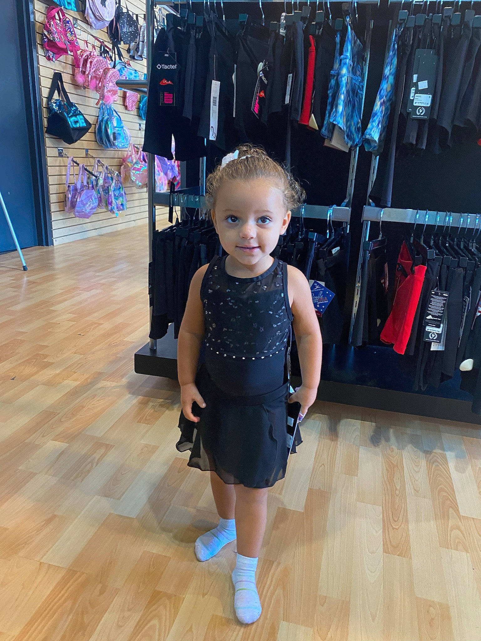 Ellianna is registered to the contest to win money with this photo: baby_toddler_clothing, bag, clothes_hanger, denim, electric_blue, eyewear, fashion_design, floor, flooring, hardwood, person, shoe, shopping, shoulder, sleeve, smile, sportswear, standing, toddler, waist