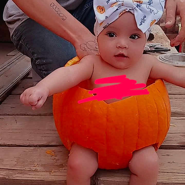 Izalia is registered to the contest to win money with this photo: baby, clothing, festival, halloween, hosiery, jack_o_lantern, person, sitting, skin, sleeve, sock, tattoo