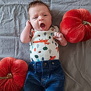 Nico joined the competition — help win amazing prizes! baby, infant, yawning, clothing, onesie, denim, pumpkin, plush, red, fabric, bed, sheet, cute, lying_down, hand, face, expression, indoor, child, casual