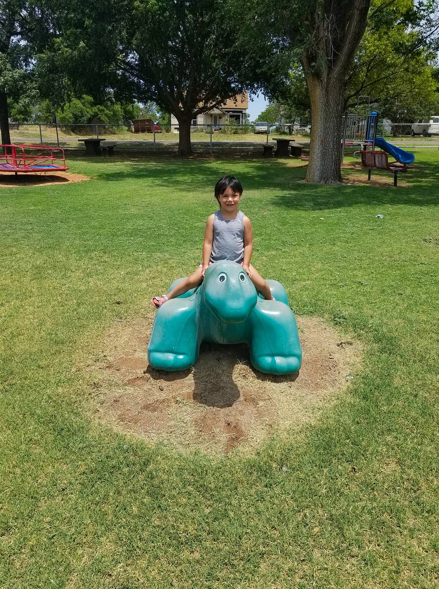 Aubrie joined the competition — help win amazing prizes! aqua, city, garden, grass, human_settlement, joy, lawn, leisure, outdoor_play_equipment, outdoor_recreation, park, person, play, playground, playground_slide, public_space, recreation, riding_toy, shade, sitting