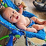 Finnegan joined the competition — help win amazing prizes! baby, bouncer, blue, indoor, child, teddy_bear, floor, rug, wood_floor, smiling, curious, seated, toy, comfort, infant, person, baby_clothes, bright, playful, relaxed