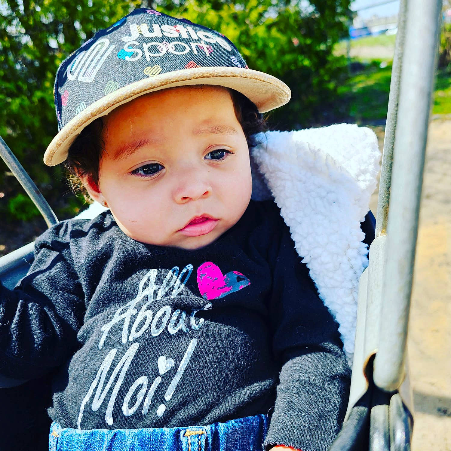 Aaliyah joined the competition — help win amazing prizes! baby, baby_carriage, baby_products, baby_toddler_clothing, cap, child, chin, electric_blue, fashion_accessory, fun, grass, happy, hat, headwear, leisure, person, recreation, sitting, sleeve, toddler