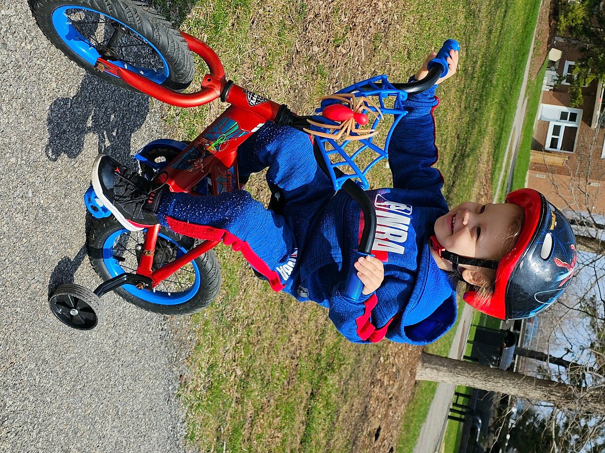 Davion is registered to the contest to win money with this photo: adventure, bicycle_helmet, carmine, child, electric_blue, extreme_sport, fun, grass, headwear, helmet, joy, leisure, person, personal_protective_equipment, plant, recreation, sports, stunt_performer, toddler, tree