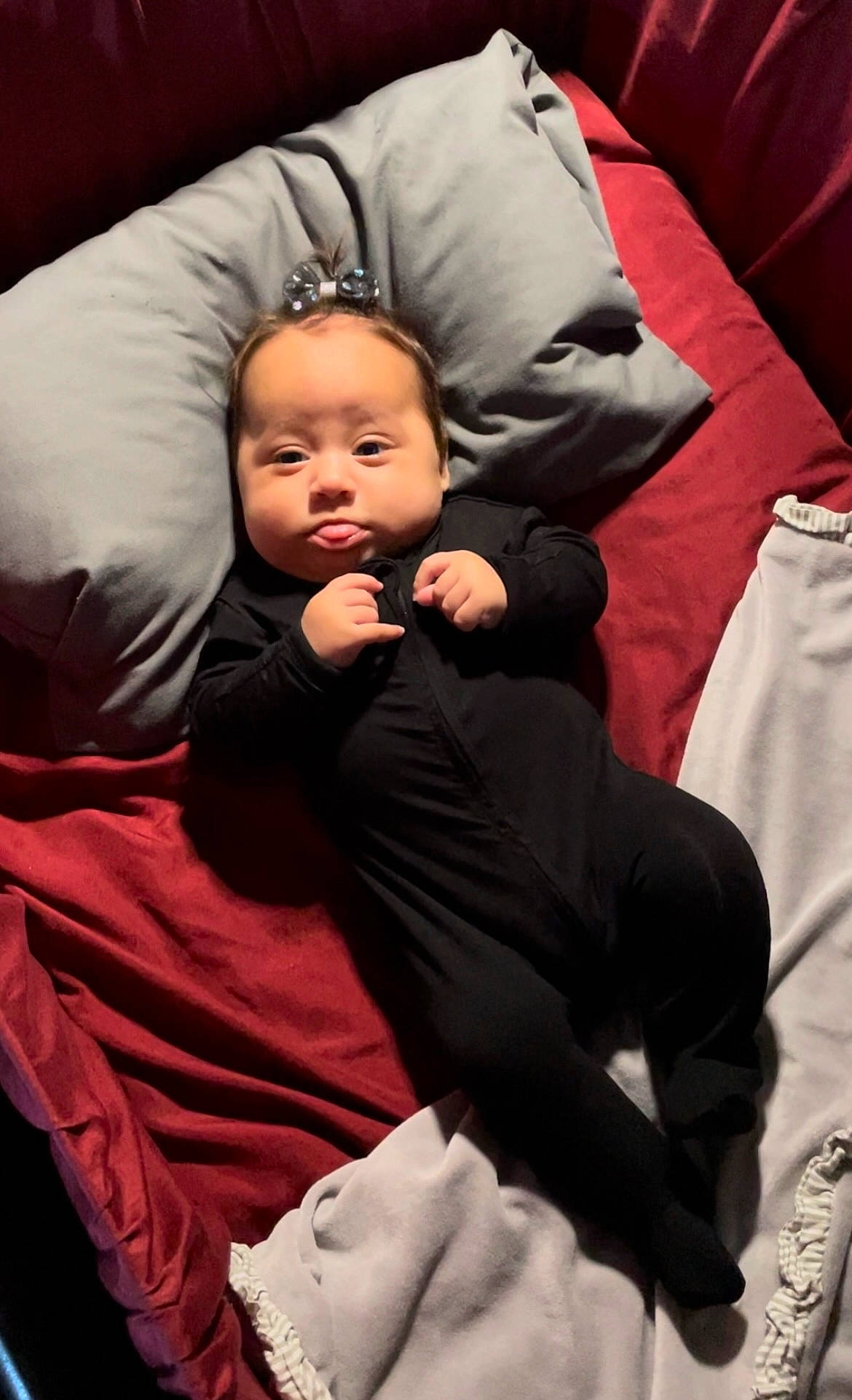 Freya is registered to the contest to win money with this photo: baby, baby_products, baby_toddler_clothing, carmine, cheek, child, comfort, event, flash_photography, formal_wear, fun, gesture, lap, linens, magenta, person, room, sitting, sleep, smile