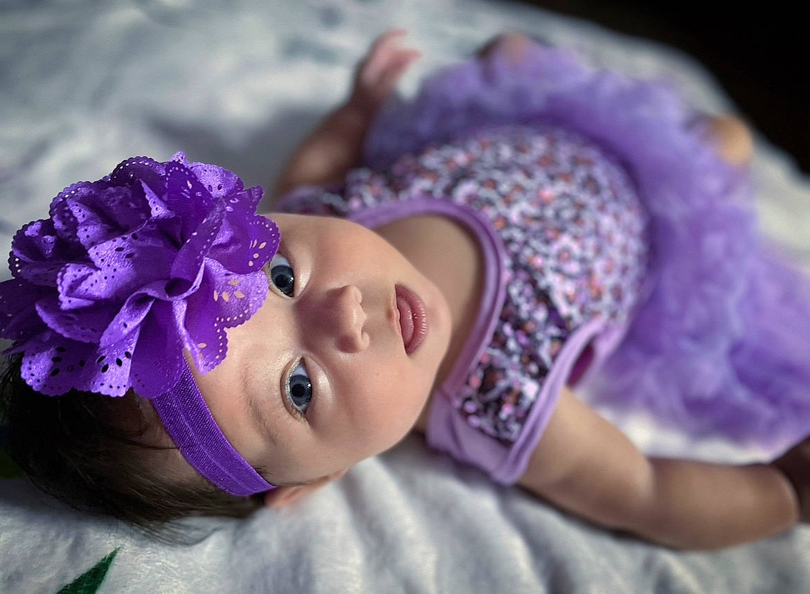 Freya is registered to the contest to win money with this photo: black_hair, child, eye, eyelash, fashion_accessory, flash_photography, flower, fun, hair_accessory, happy, headband, headgear, headpiece, headwear, lip, magenta, person, petal, pink, plant