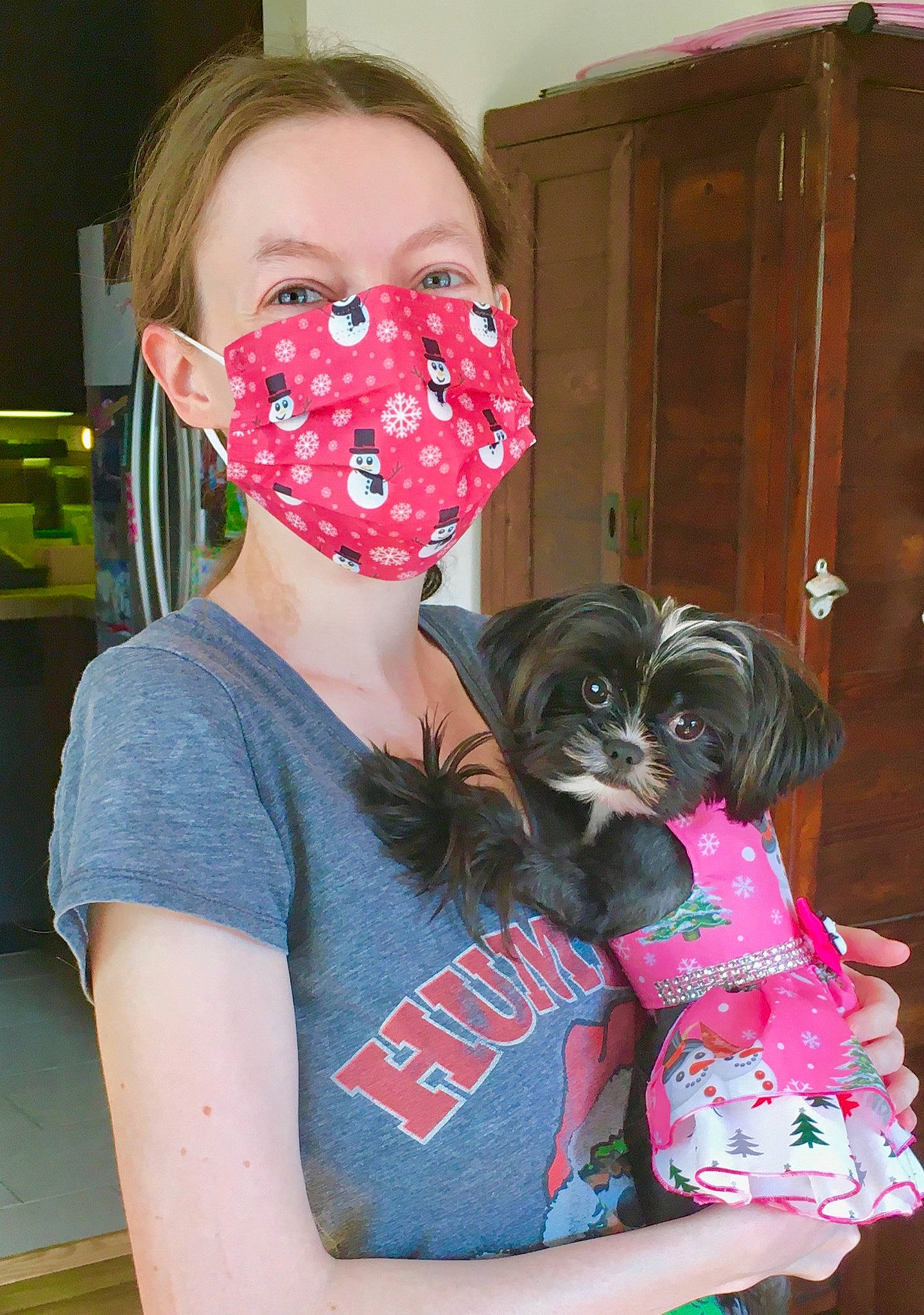 Truffles is registered to the contest to win money with this photo: black_hair, carnivore, companion_dog, costume, dog, dog_breed, dog_supply, door, event, eyewear, fawn, hairstyle, magenta, pattern, personal_protective_equipment, pink, purple, sporting_group, t_shirt, toy_dog
