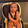 Beckham is registered to the contest to win money with this photo: baby, high_chair, food, messy, kitchen, diaper, child, face, hands, seat_belt, indoor, expression, floor, tile, light, window, countertop, plastic, straps, furniture