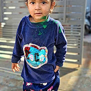 Gurfateh Singh joined the competition — help win amazing prizes! child, toddler, paint, messy, navy_blue, shirt, pants, sandals, top_knot, outdoor, sunlight, face, eyes, standing, expression, gate, pavement, clothing, casual, colorful
