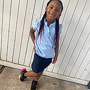 Miracle is registered to the contest to win money with this photo: child, girl, braids, pink_hair, blue_shirt, skirt, sneakers, colorful_shoes, outdoor, concrete, fence, playful, smiling, posing, earrings, casual_clothing, daylight, sidewalk, happy, portrait