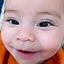 baby, close_up, face, smile, child, eyelashes, cheeks, skin, orange_sweater, joyful, innocence, cute, portrait, happy, young, infant, cute_expression, bright_eyes, human, childhood