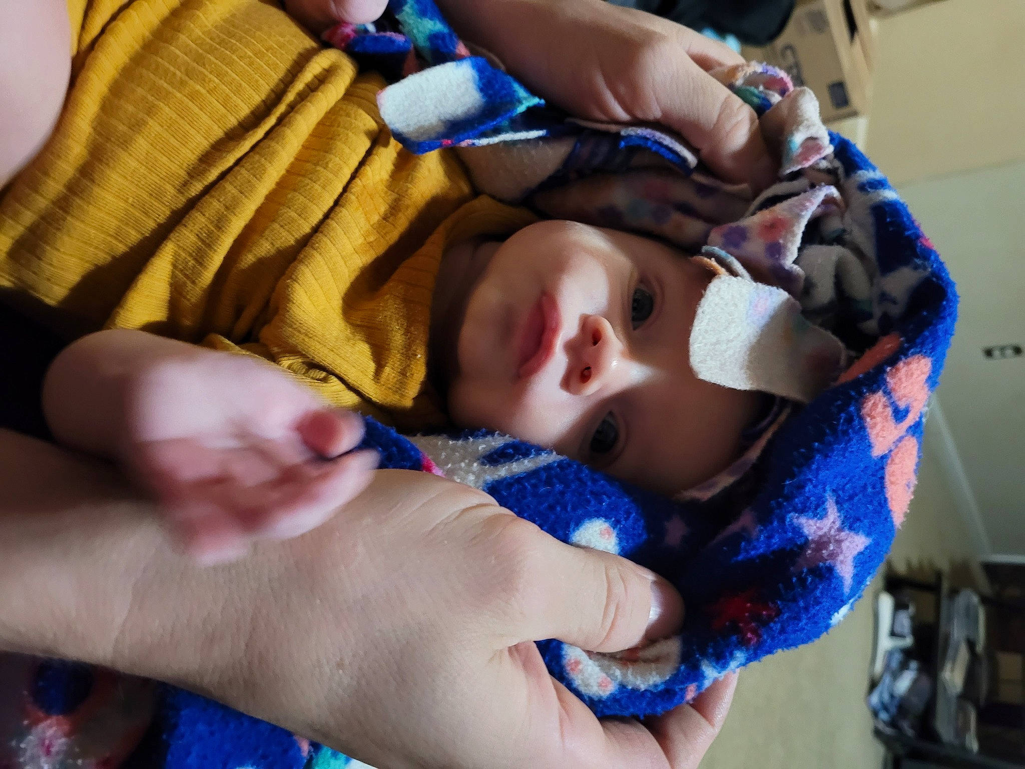 Ian is registered to the contest to win money with this photo: baby, baby_products, baby_toddler_clothing, blue, cheek, chest, child, comfort, electric_blue, eyelash, finger, gesture, headwear, mouth, nail, pattern, person, skin, textile, thumb