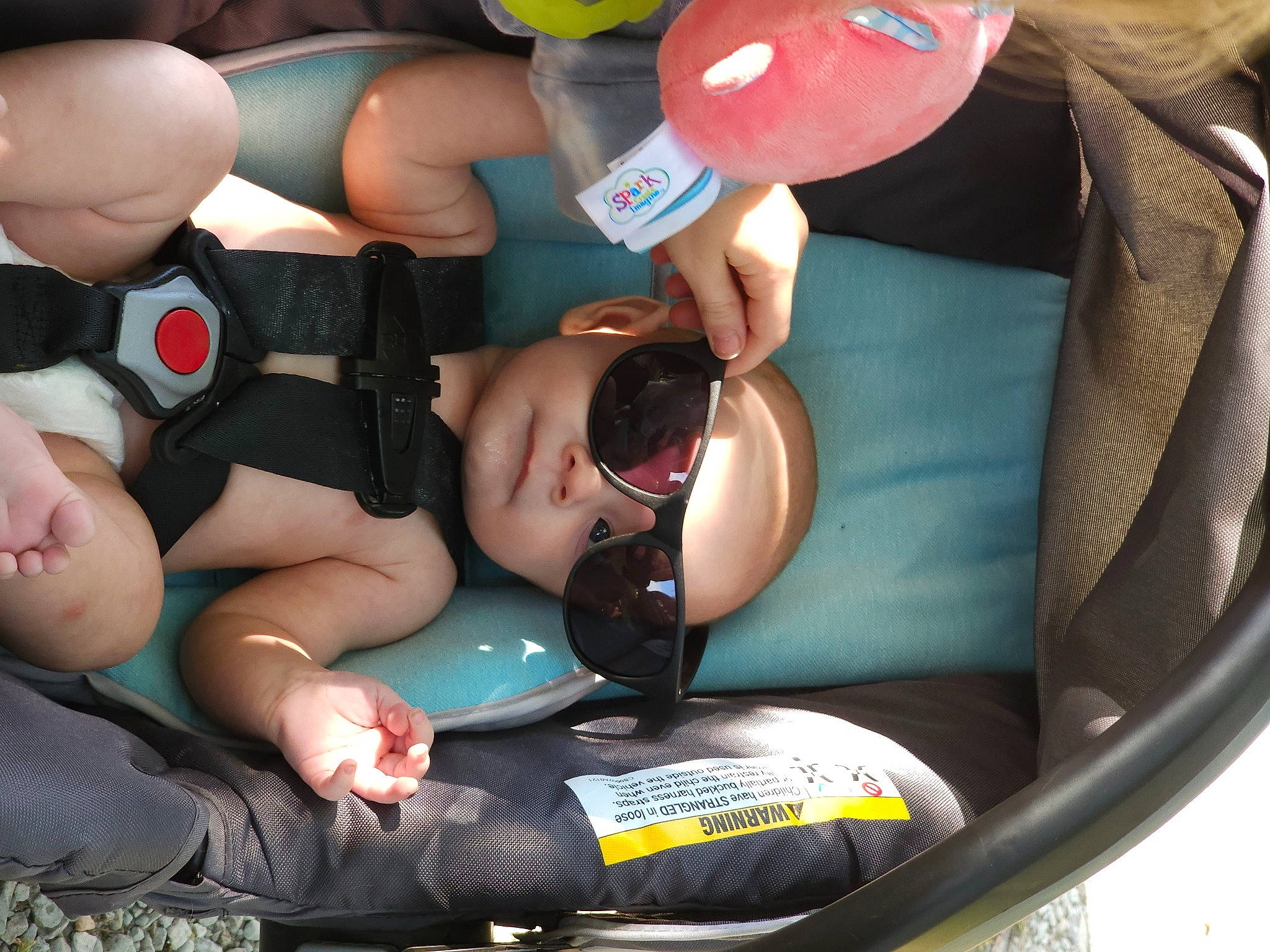 Ian is registered to the contest to win money with this photo: abdomen, baby_products, balloon, car_seat, chest, child, comfort, event, fun, hat, headwear, human_leg, inflatable, knee, leisure, party_supply, person, personal_protective_equipment, recreation, shorts