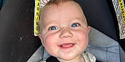 Kaelen is registered to the contest to win money with this photo: baby, smiling, dinosaur_shirt, car_seat, harness, blue_eyes, child, young_child, cute, happy, infant, seatbelt, strapped_in, warning_label, close_up, portrait, child_safety, casual_clothing, indoor, seat
