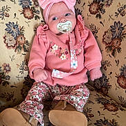 Willow joined the competition — help win amazing prizes! baby, boots, bow, cushion, eyes, face, floral_pattern, hands, headband, home_interior, infant, legs, mouth, pacifier, patterned_fabric, pink_outfit, portrait, sofa, upholstery, wood_paneling