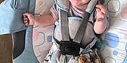 Esteban a rejoint le concours — aidez-le/la à gagner de superbes lots ! baby, baby_rocker, bear_face, child, clothing, comfort, cushion, cute, face, happy, indoor, infant, patterned_pants, person, playful, seat, smiling, socks, straps, wooden_floor