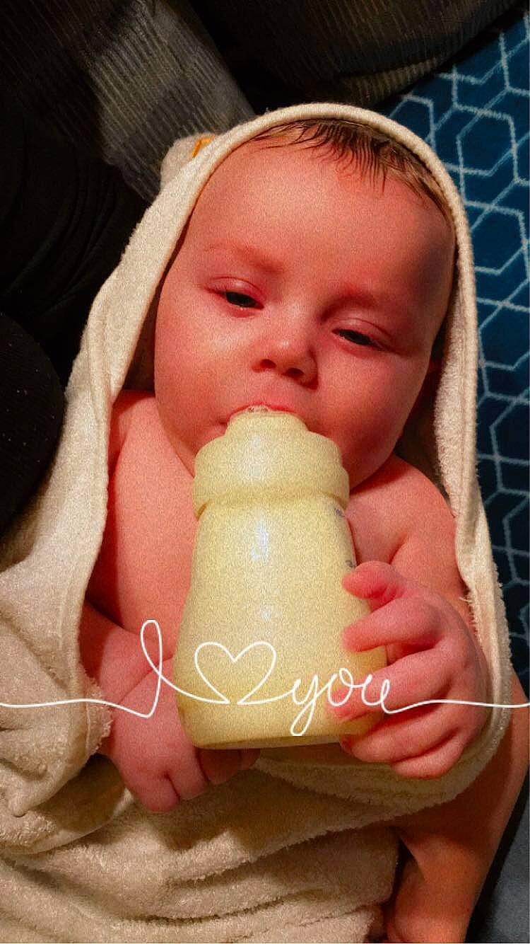 Branson is registered to the contest to win money with this photo: baby, baby_sleeping, cheek, comfort, drinkware, ear, eyelash, face, finger, gesture, hair, hand, happy, human_body, lip, mouth, neck, nose, person, pink