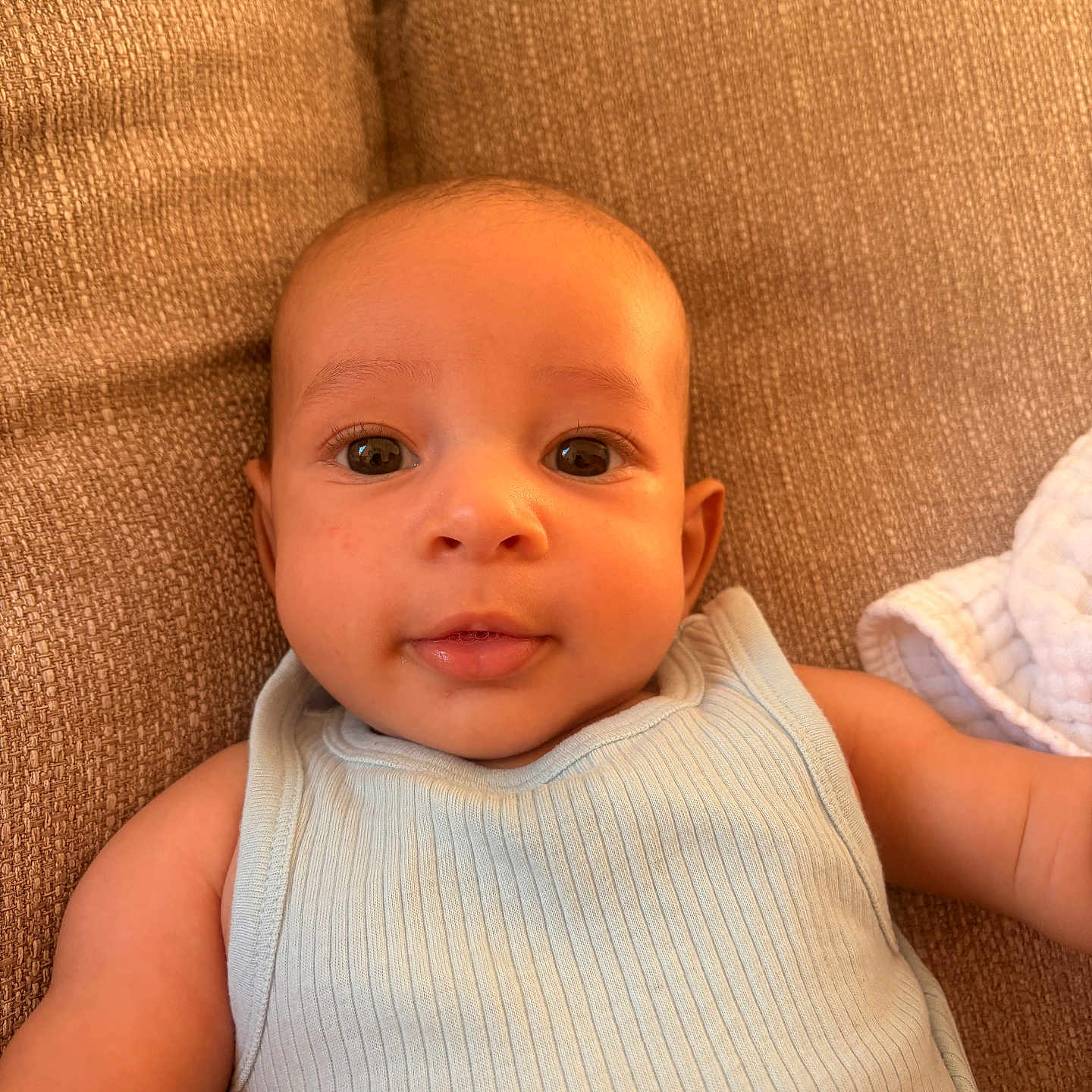 Jamesy participe au concours pour gagner de l'argent avec cette photo : arm, baby, child, closeup, clothing, couch, cute, eyes, fabric, face, indoor, infant, person, portrait, relax, skin, sleeveless, smile, texture, young