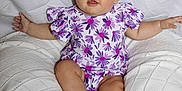 Mylee joined the competition — help win amazing prizes! baby, child, purple_bow, floral_outfit, cushion, knitted_blanket, white_background, sitting, cute, chubby_legs, happy, indoors, portrait, infant, smiling, blue_eyes, curious, clothing, soft_texture, comfortable
