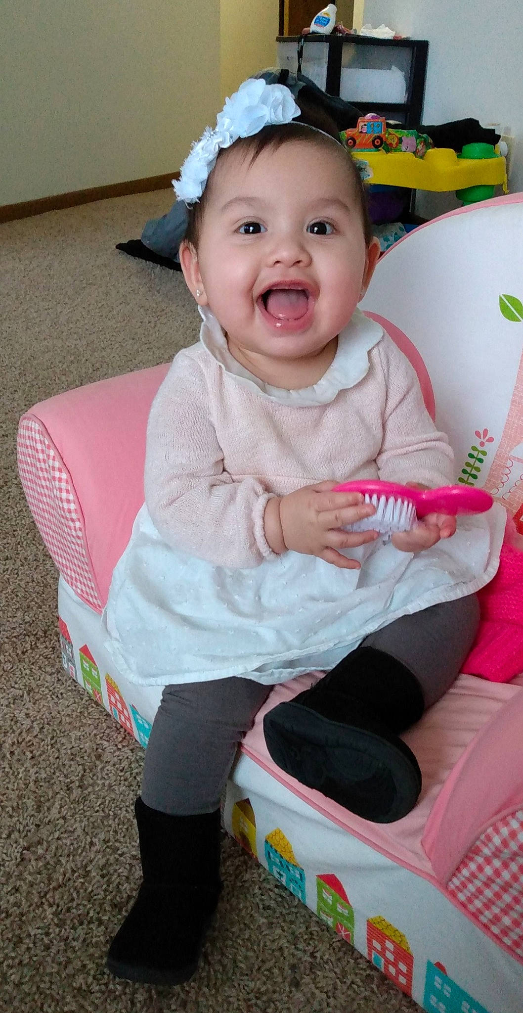 Aubrianna joined the competition — help win amazing prizes! baby, baby_laughing, baby_products, baby_toddler_clothing, boot, child, eye, hair_accessory, headband, headpiece, human_body, lap, laugh, person, pink, shoe, sock, toddler, tongue