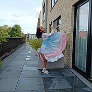 Yora participe au concours pour gagner de l'argent avec cette photo : balcony, ballet_pose, brick_wall, building, child, clouds, daylight, dress, footwear, girl, glass_door, glasses, greenery, outdoor, plant, pose, reflection, sky, tiles, window