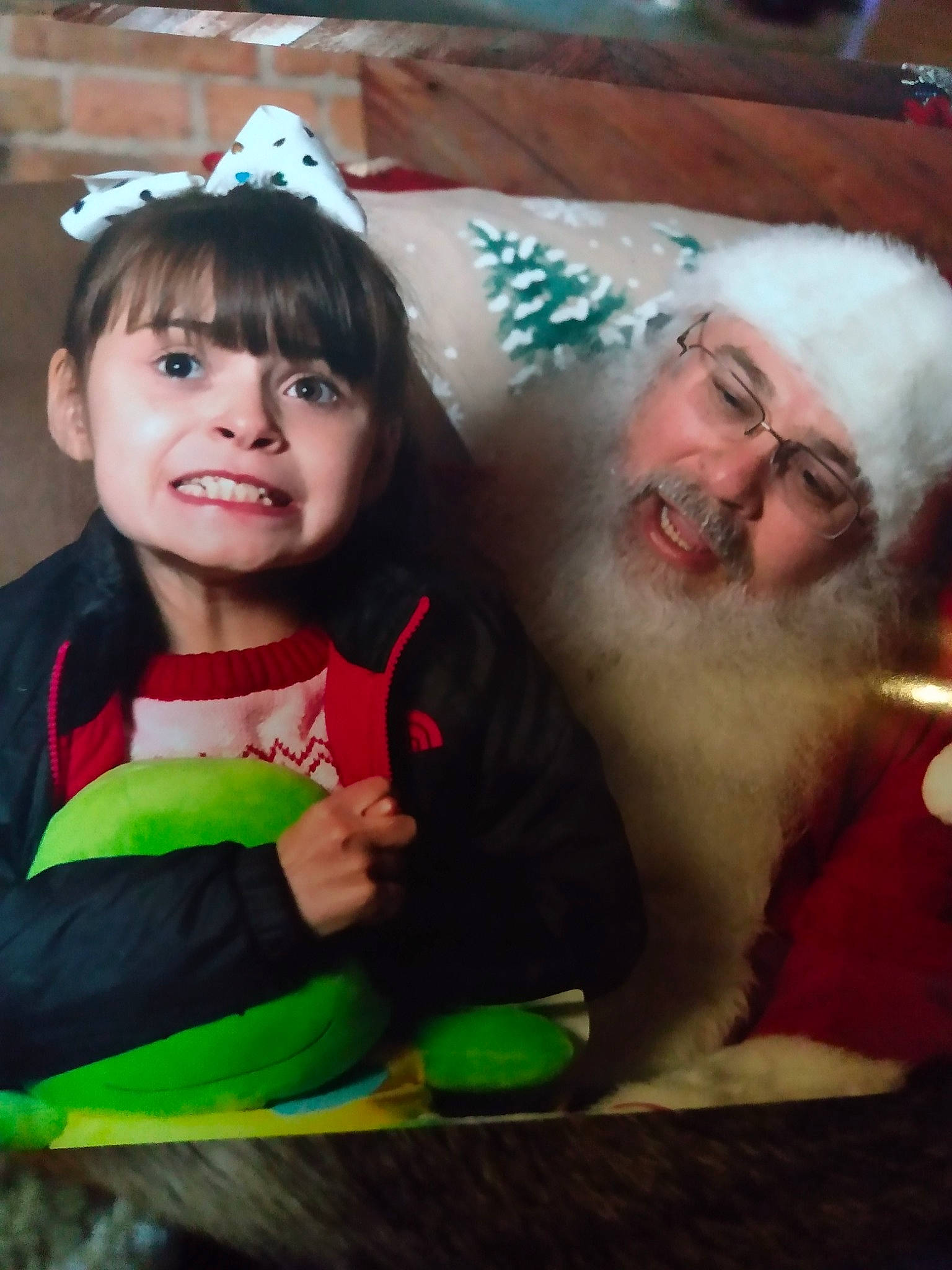 Raelynn is registered to the contest to win money with this photo: bangs, beard, child, christmas, christmas_eve, costume_hat, event, facial_expression, facial_hair, fun, hairstyle, happy, hat, headwear, holiday, human, joy, lap, person, santa_claus