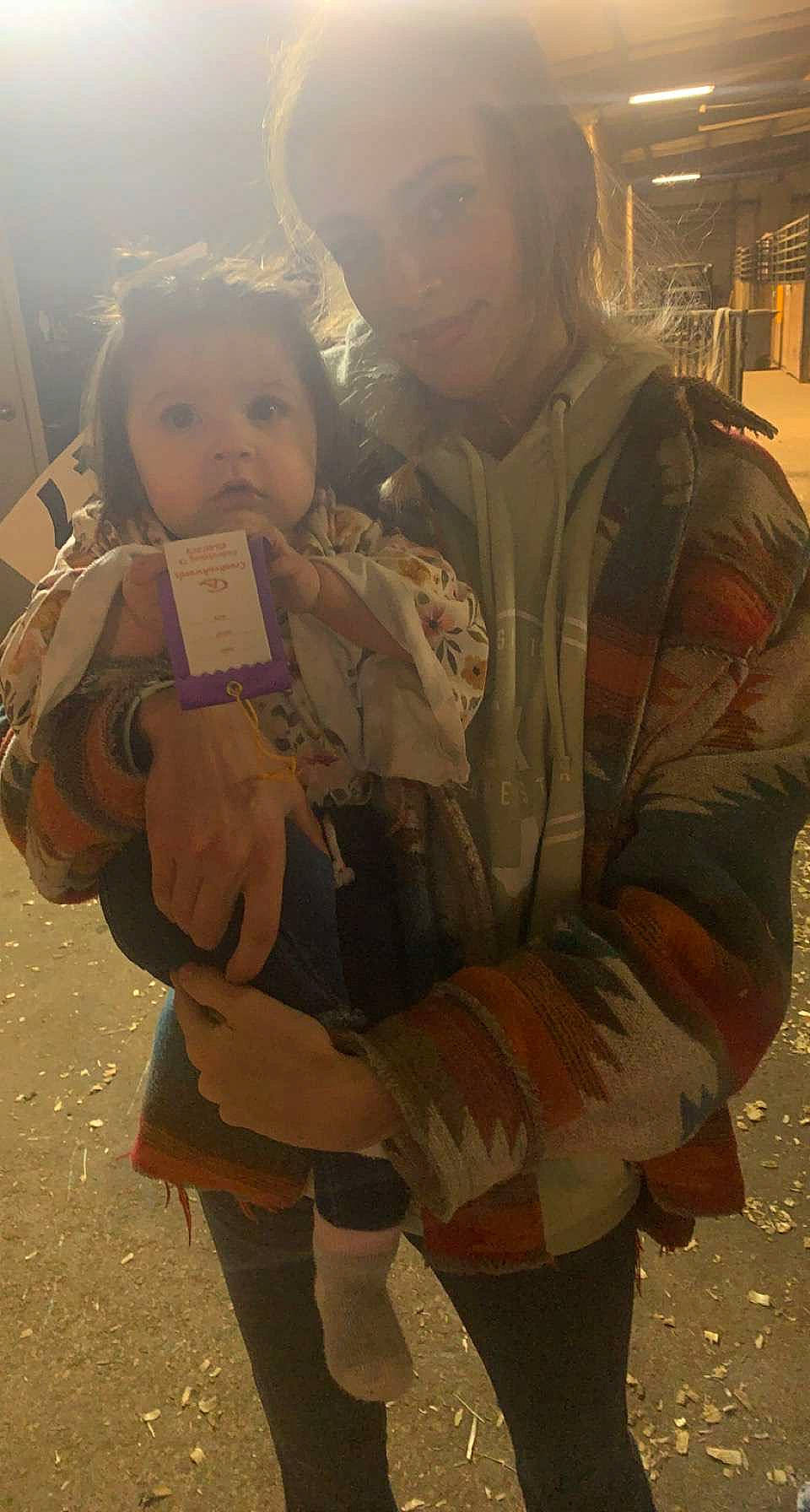 Baylor is registered to the contest to win money with this photo: bag, child, costume, event, face, fun, fur, glove, happy, human_leg, landscape, luggage_and_bags, person, sitting, sleeve, snapshot, temple, thigh, toddler, tourism