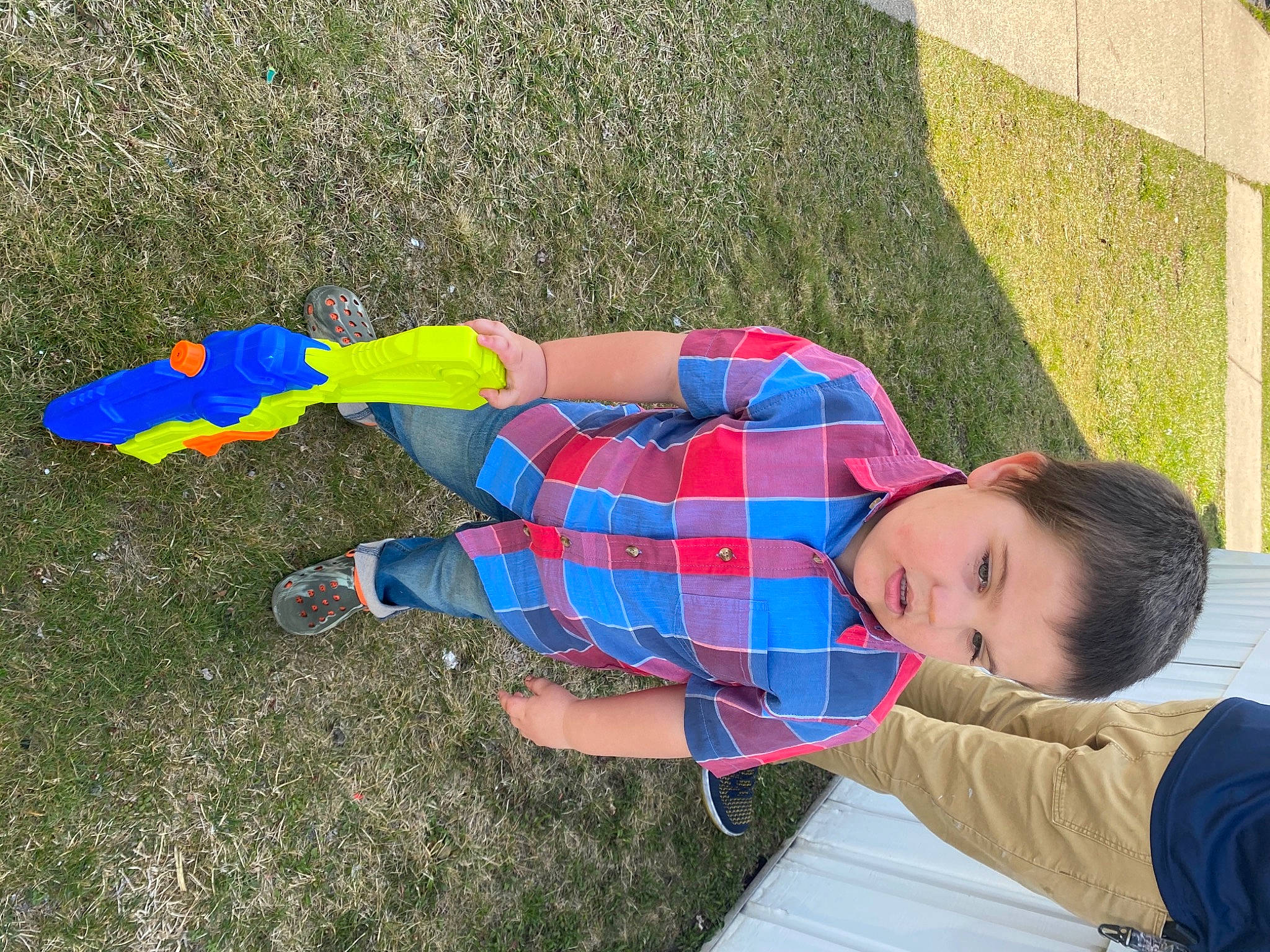 Lincoln joined the competition — help win amazing prizes! child, electric_blue, fun, grass, grass_family, grassland, lawn, leisure, pattern, people_in_nature, person, plaid, play, recreation, shadow, shoe, sitting, soil, t_shirt, tartan