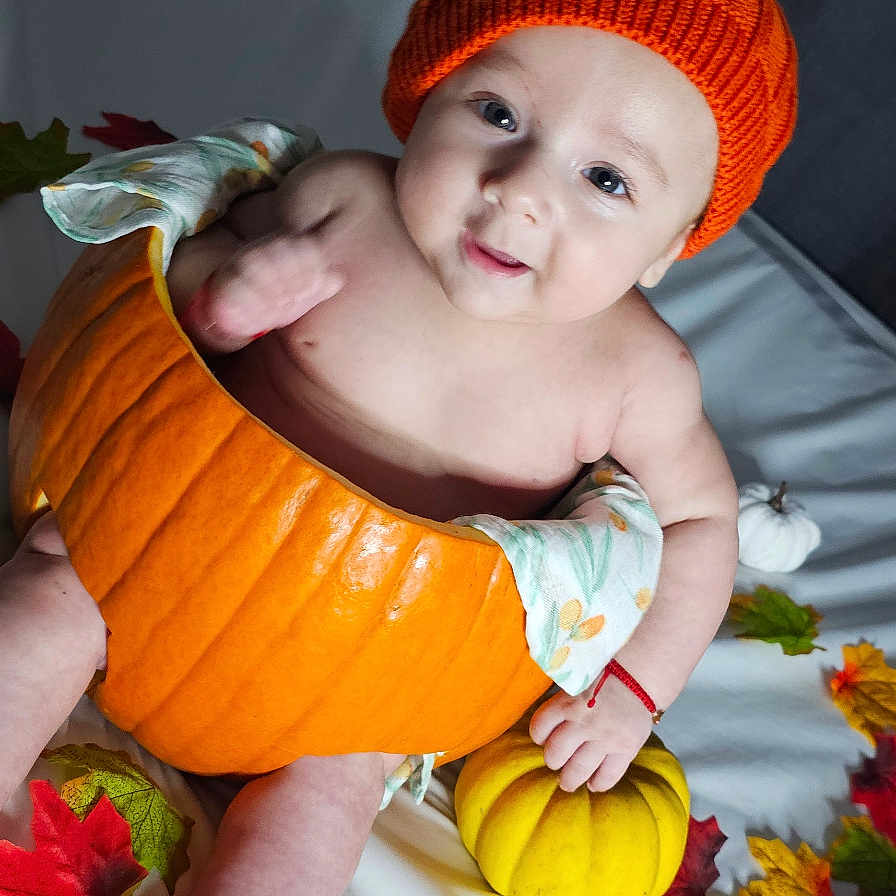 Noah joined the competition — help win amazing prizes! autumn_leaves, baby, blanket, child, cozy, cute, fall_decor, festive, hat, indoors, infant, knitted, orange, pinecone, pumpkin, seasonal, sitting, smiling, white, yellow