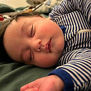 Liam joined the competition — help win amazing prizes! baby, sleeping, infant, face, striped_clothing, blue, white, hand, soft, blanket, cozy, peaceful, rosy_cheeks, closeup, portrait, resting, child, cute, indoors, young