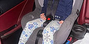 Aurora is registered to the contest to win money with this photo: accessories, belt, car, car_interior, carseat, clothing, cushion, face, footwear, head, homedecor, jeans, pants, person, seatbelt, shoe, sitting, sneaker, transportation, vehicle