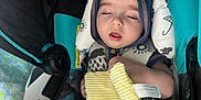Taytum is registered to the contest to win money with this photo: baby, sleeping, car_seat, blanket, hooded_clothing, infant, child, face, hand, comfort, soft_toy, tag, cushion, nap, rest, indoors, young_child, cute, peaceful, cozy