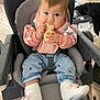 Valentina participe au concours pour gagner de l'argent avec cette photo : baby, child, high_chair, snack, bib, jeans, booties, mouse_design, indoor, home, flooring, furniture, cute, pink, gray, person, seated, looking_at_camera, hands, footwear