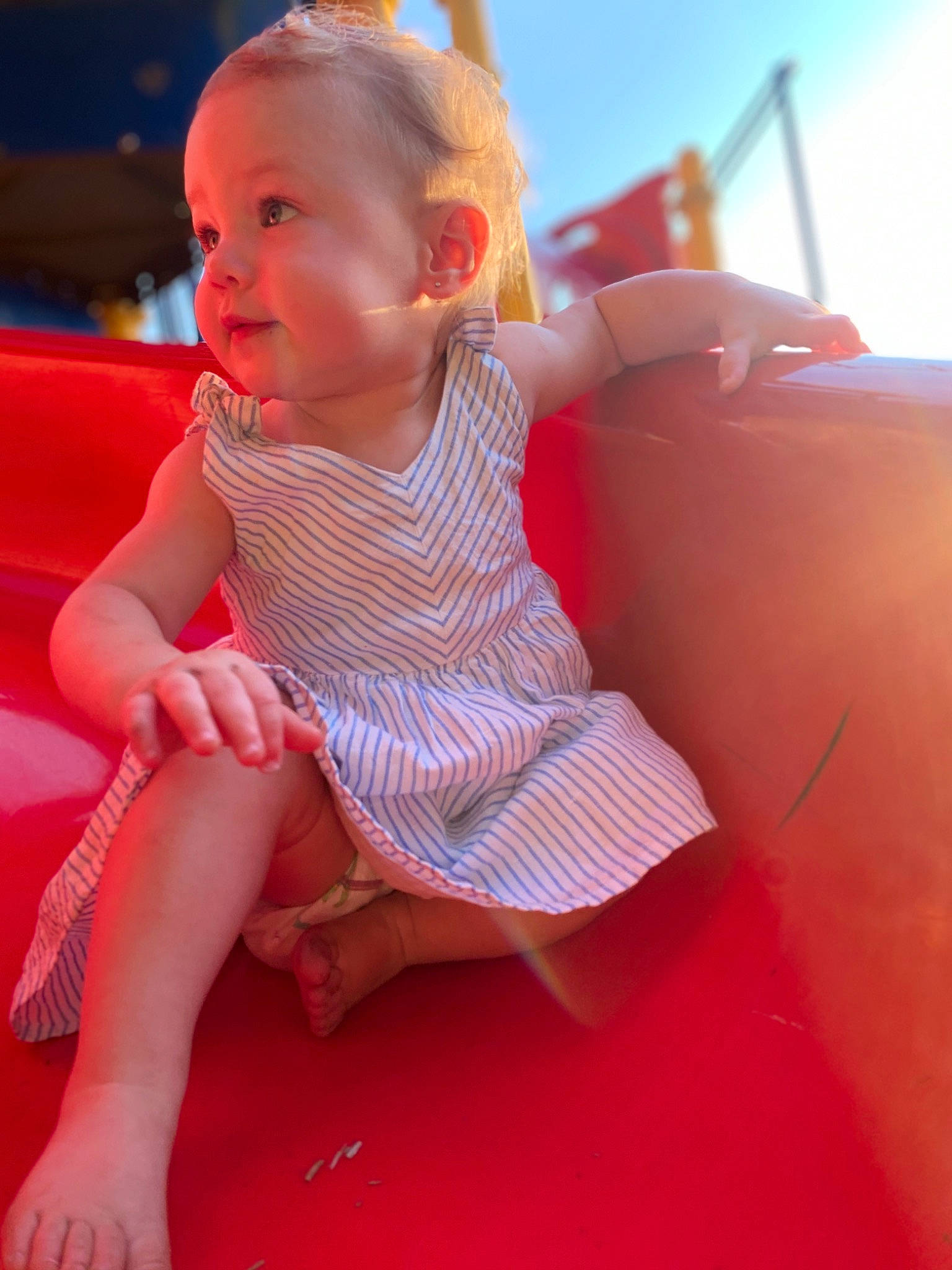 Marli joined the competition — help win amazing prizes! baby, blond, child, fun, games, inflatable, leg, leisure, outdoor_play_equipment, person, play, playground, playground_slide, recreation, red, sitting, skin, smile, summer, toddler