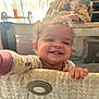 Amelia joined the competition — help win amazing prizes! toddler, child, smile, happy, playpen, pajamas, curly_hair, indoors, baby, hand, furniture, blanket, mesh, face, person, home, cozy, cute, infant, grin