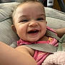 Amelia is registered to the contest to win money with this photo: baby, smiling, happy, infant, child, seatbelt, carseat, pink_clothing, face, skin, arm, cushion, indoor, closeup, portrait, cute, expression, person, baby_toy, hair