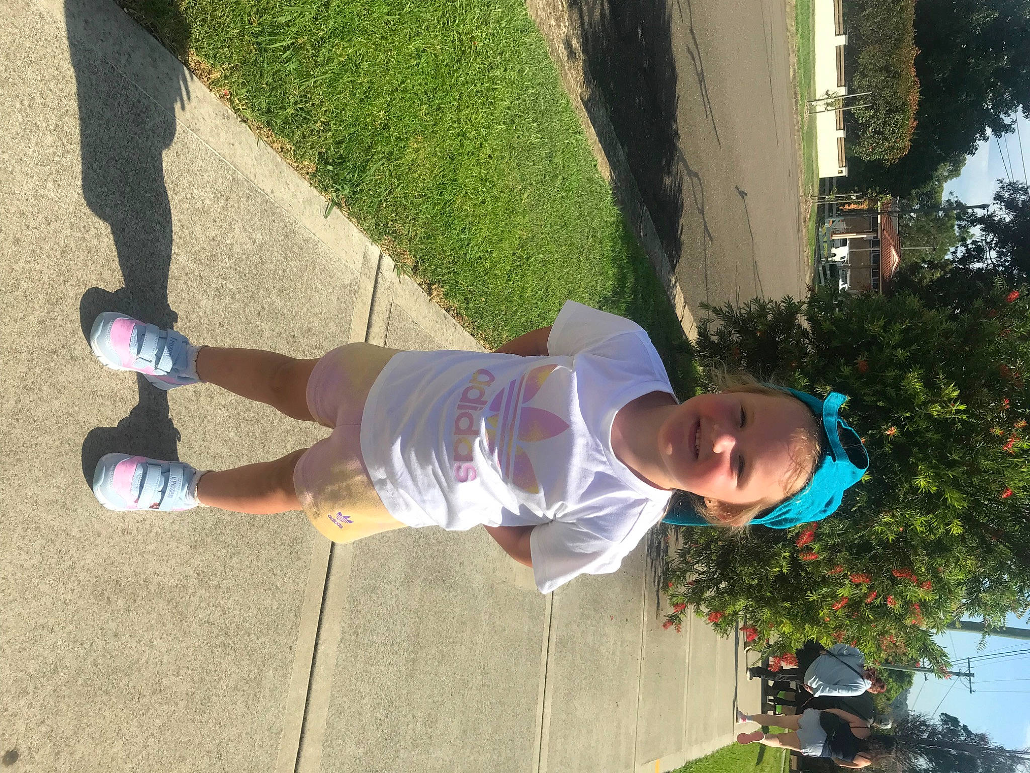 Hayley is registered to the contest to win money with this photo: asphalt, calf, electric_blue, foot, fun, grass, human_leg, joy, knee, leg, leisure, pedestrian, person, plant, recreation, shorts, shrub, sock, t_shirt, thigh
