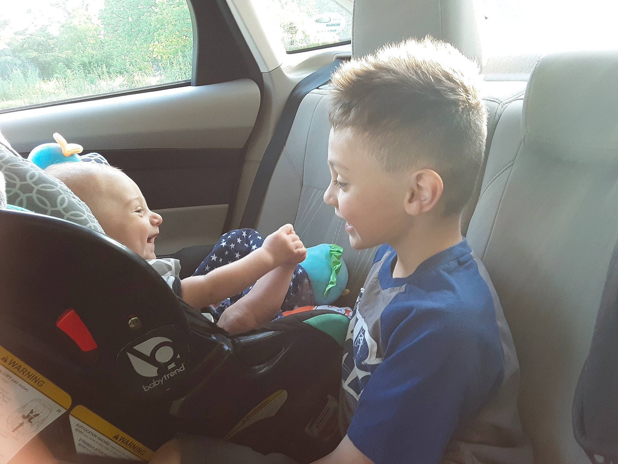 Eden is registered to the contest to win money with this photo: auto_part, baby, baby_in_car_seat, birth, car, car_seat, car_seat_cover, child, driving, ear, family_car, leg, person, seat_belt, sitting, steering_wheel, toddler, vacation, vehicle, vehicle_door