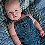 baby, infant, denim_overalls, blue_quilt, bed, lying_down, child, cute, soft_lighting, portrait, face, skin, hand, clothing, fabric, baby_fashion, casual, indoor, newborn, young_child