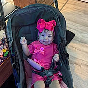 Nashly joined the competition — help win amazing prizes! baby, baby_carriage, bow, candid, child, facial_expression, family_photo, fashion, furniture, hands, happy, home, indoor, infant, pink_clothing, portrait, sitting, smiling, stroller, wood_floor