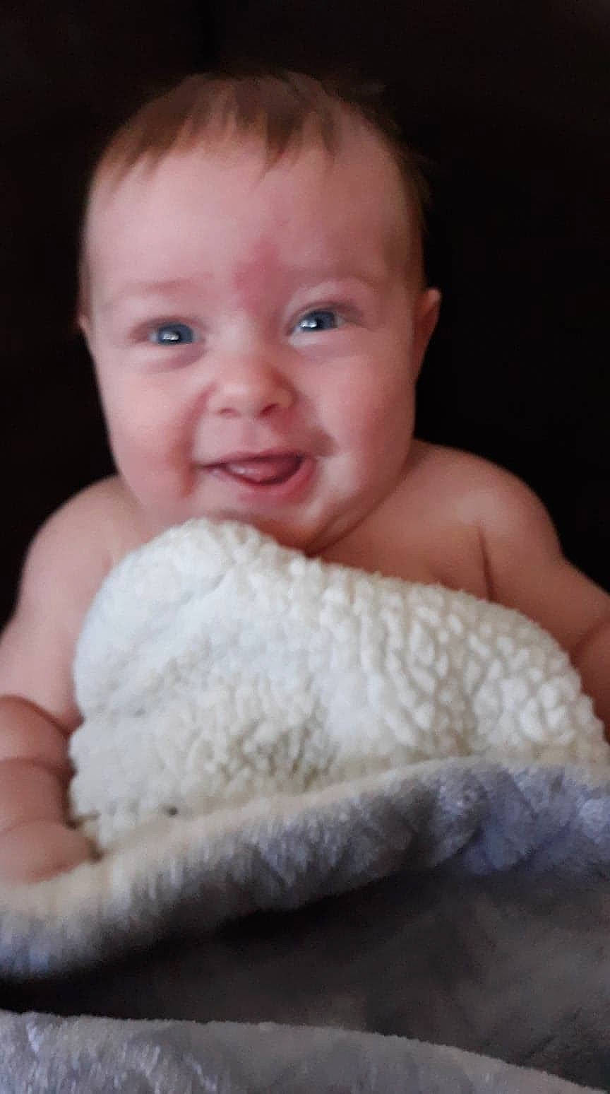 Kayden is registered to the contest to win money with this photo: baby, cheek, child, chin, face, facial_expression, fur, hand, head, lip, mouth, nose, person, sitting, skin, smile, toddler