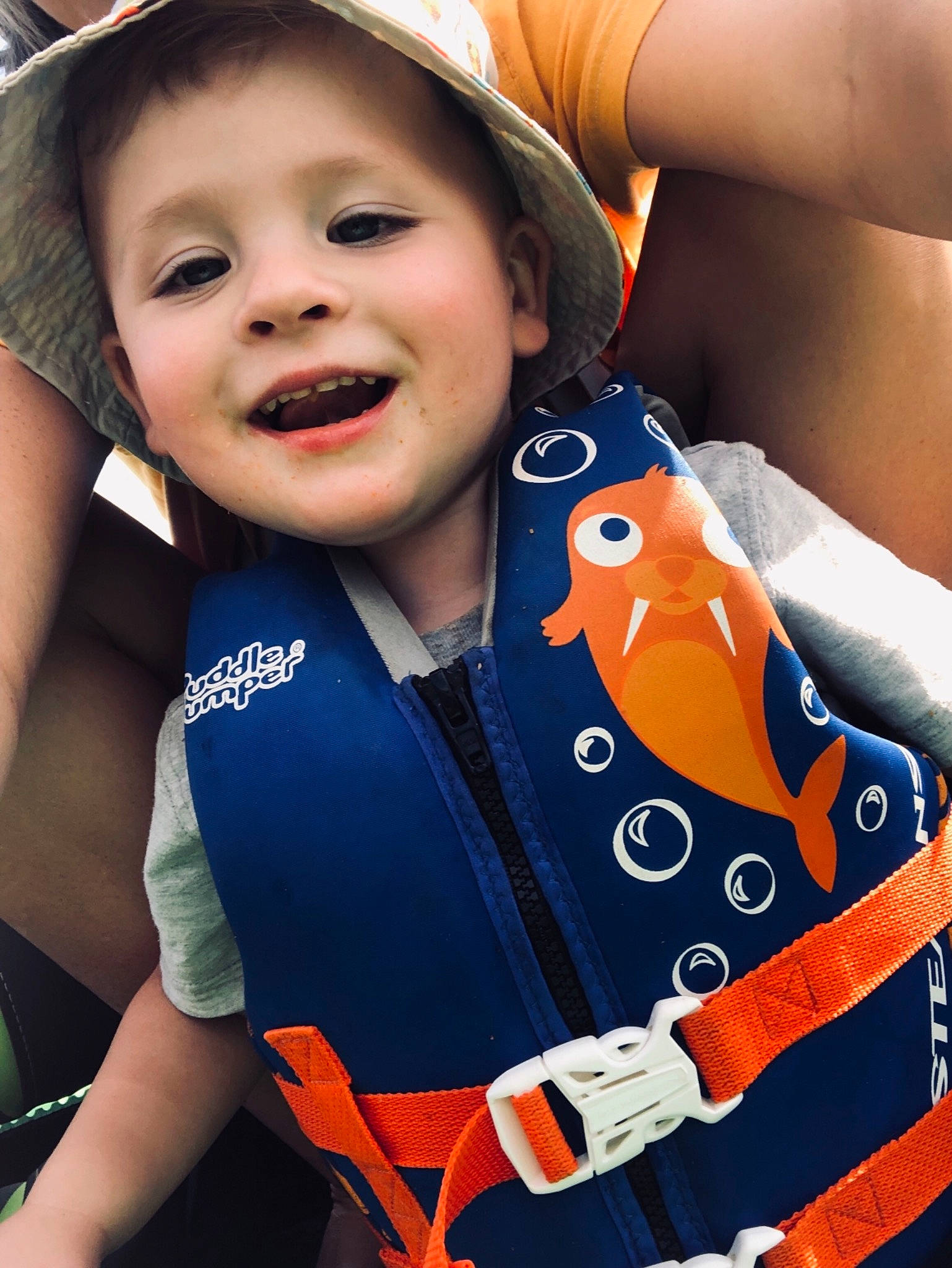 Nate is registered to the contest to win money with this photo: baby_products, child, fashion_accessory, hat, headgear, joy, lifejacket, person, personal_protective_equipment, product, seat_belt, smile, toddler